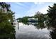 Calm waterway with boats docked and lush vegetation along the banks at 5112 Jungle Plum Rd, Sarasota, FL 34242