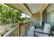Small balcony with seating area, overlooking lush greenery at 5369 Lake Arrowhead Trl # 17A, Sarasota, FL 34231