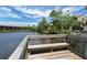 Wooden dock with a bench overlooking a serene lake at 5369 Lake Arrowhead Trl # 17A, Sarasota, FL 34231