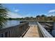 Wooden dock with a bench overlooking a serene lake at 5369 Lake Arrowhead Trl # 17A, Sarasota, FL 34231