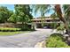 Lake Arrowhead community entrance with covered parking and lush landscaping at 5369 Lake Arrowhead Trl # 17A, Sarasota, FL 34231