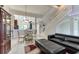 Open living area with black leather sectional sofa and access to a screened-in patio at 5369 Lake Arrowhead Trl # 17A, Sarasota, FL 34231