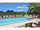 Community pool with plenty of lounge chairs for relaxation at 5369 Lake Arrowhead Trl # 17A, Sarasota, FL 34231