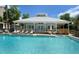 Community pool with a cabana and plenty of lounge chairs at 5369 Lake Arrowhead Trl # 17A, Sarasota, FL 34231