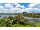 Serene waterfront view from a condo balcony, showcasing lush landscaping at 5369 Lake Arrowhead Trl # 17A, Sarasota, FL 34231