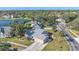 Aerial view of a single-Gathering home with a lake and lush landscaping at 5384 Sarapointe Ct, Sarasota, FL 34232