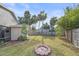 Spacious backyard with firepit and lush landscaping at 5384 Sarapointe Ct, Sarasota, FL 34232