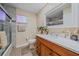 Clean bathroom with a tub shower combo and wood vanity at 5384 Sarapointe Ct, Sarasota, FL 34232