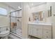 Updated bathroom with a walk-in shower and modern vanity at 5384 Sarapointe Ct, Sarasota, FL 34232