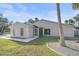 Tan house with a screened porch and palm trees at 5384 Sarapointe Ct, Sarasota, FL 34232