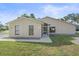 Tan house with a screened porch and well-manicured lawn at 5384 Sarapointe Ct, Sarasota, FL 34232