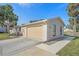 Tan house with attached garage and a walkway at 5384 Sarapointe Ct, Sarasota, FL 34232