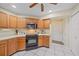 Kitchen with wood cabinets, stainless steel appliances and tiled floors at 5384 Sarapointe Ct, Sarasota, FL 34232
