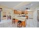 Kitchen with wood cabinets, stainless steel appliances, and an island with seating at 5384 Sarapointe Ct, Sarasota, FL 34232