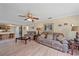 Open living room with hardwood floors and comfortable seating, adjacent to the kitchen at 5384 Sarapointe Ct, Sarasota, FL 34232