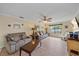 Spacious living room featuring hardwood floors, plush sofas, and access to the backyard at 5384 Sarapointe Ct, Sarasota, FL 34232