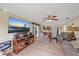 Bright living room with hardwood floors, comfortable seating, and a view into the kitchen at 5384 Sarapointe Ct, Sarasota, FL 34232