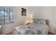 Small bedroom with full-size bed and floral bedding at 5507 Fair Oaks St # 3-C, Bradenton, FL 34203