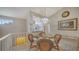 Cozy dining area with glass table and wicker chairs at 5507 Fair Oaks St # 3-C, Bradenton, FL 34203