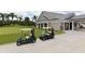 Golf carts parked by a clubhouse with palm trees at 5507 Fair Oaks St # 3-C, Bradenton, FL 34203
