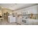 Bright kitchen with white cabinets, built-in microwave, and tile flooring at 5507 Fair Oaks St # 3-C, Bradenton, FL 34203