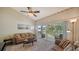Living room with patio doors leading to a balcony overlooking a lake at 5507 Fair Oaks St # 3-C, Bradenton, FL 34203
