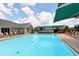 Community pool with lounge chairs and umbrellas at 5507 Fair Oaks St # 3-C, Bradenton, FL 34203