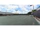 Well-lit tennis courts with benches at 5507 Fair Oaks St # 3-C, Bradenton, FL 34203