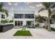 Spacious backyard oasis with a spa, patio, and lounge chairs at 5906 Larchwood Ave, Sarasota, FL 34231