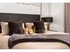King-size bed with plush pillows and bedding in a modern bedroom at 5906 Larchwood Ave, Sarasota, FL 34231