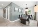Elegant dining room with a large table and gray accent wall at 5906 Larchwood Ave, Sarasota, FL 34231