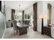 Modern dining room features a concrete table, gray chairs, and access to a backyard patio at 5906 Larchwood Ave, Sarasota, FL 34231