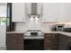 Sleek kitchen with stainless steel range, microwave, and modern cabinetry at 5906 Larchwood Ave, Sarasota, FL 34231