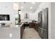 Modern kitchen with stainless steel appliances and dark wood cabinetry at 5906 Larchwood Ave, Sarasota, FL 34231