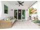 Covered patio with wicker sofa and sliding glass doors at 5906 Larchwood Ave, Sarasota, FL 34231
