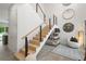 Modern staircase with light wood treads and metal railing at 5906 Larchwood Ave, Sarasota, FL 34231