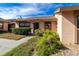 Tan exterior condo with a well-maintained lawn and walkway at 6135 Heritage Ln # 6135, Bradenton, FL 34209