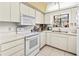 Bright kitchen with white cabinets and appliances at 6135 Heritage Ln # 6135, Bradenton, FL 34209