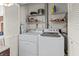 Laundry room with washer, dryer, and shelving at 6135 Heritage Ln # 6135, Bradenton, FL 34209