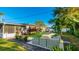 Modern backyard features a putting green, patio furniture and tropical landscaping at 6726 S Lockwood Ridge Rd, Sarasota, FL 34231