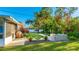 Modern backyard features a putting green, patio furniture and tropical landscaping at 6726 S Lockwood Ridge Rd, Sarasota, FL 34231