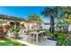Relaxing patio features a dining table and umbrella, surrounded by greenery at 6726 S Lockwood Ridge Rd, Sarasota, FL 34231