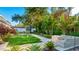 Landscaped backyard oasis with putting green, patio furniture, and dining area at 6726 S Lockwood Ridge Rd, Sarasota, FL 34231
