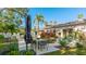 Outdoor patio with dining table, umbrella, and lush landscaping at 6726 S Lockwood Ridge Rd, Sarasota, FL 34231