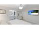 Spacious bedroom with large TV and en-suite bathroom at 6726 S Lockwood Ridge Rd, Sarasota, FL 34231