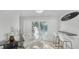 Modern breakfast bar with white stools and access to backyard at 6726 S Lockwood Ridge Rd, Sarasota, FL 34231