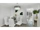 Bright dining room with glass table, white chairs, and modern chandelier at 6726 S Lockwood Ridge Rd, Sarasota, FL 34231