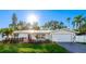 White single-story home with landscaped lawn and attached garage at 6726 S Lockwood Ridge Rd, Sarasota, FL 34231