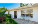 Modern front entry with seating area and landscaping at 6726 S Lockwood Ridge Rd, Sarasota, FL 34231