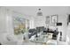 Bright home office features a glass desk, comfortable seating, and large window at 6726 S Lockwood Ridge Rd, Sarasota, FL 34231